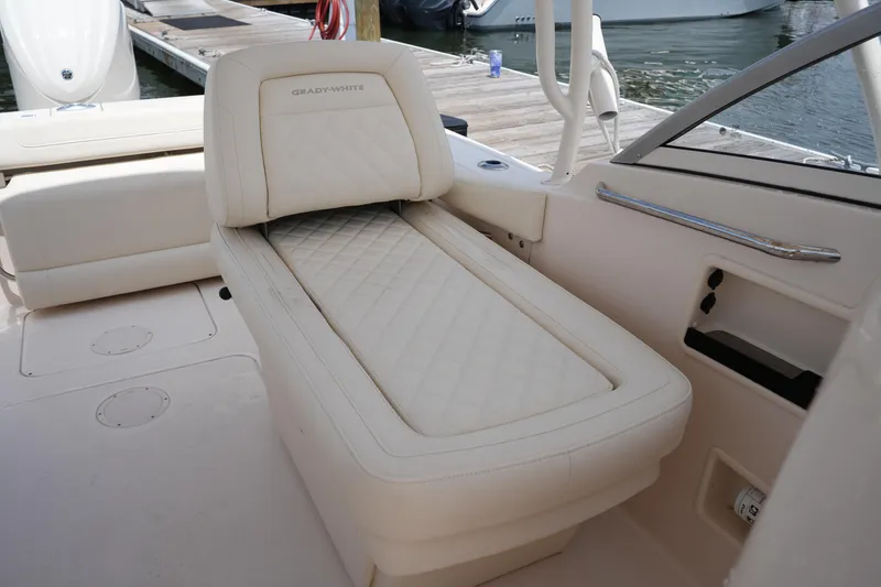 Slide: The Image of 2023 Grady-White Freedom 235 boat interior with luxurious seating and dock view. - 22