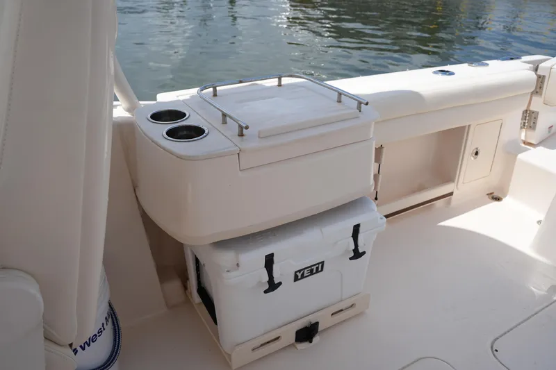 Slide: The Image of 2023 Grady-White Freedom 235 boat interior with Yeti cooler and cup holders. - 23