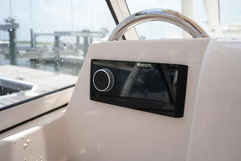 Slide: The Image of 2023 Grady-White Freedom 235 boat dashboard with Fusion audio system. - 33