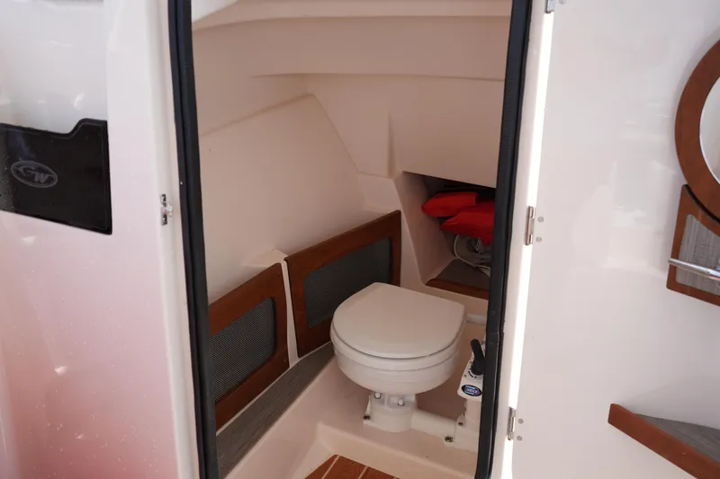 Slide: The Image of 2023 Grady-White Freedom 235 boat interior with compact marine toilet. - 35