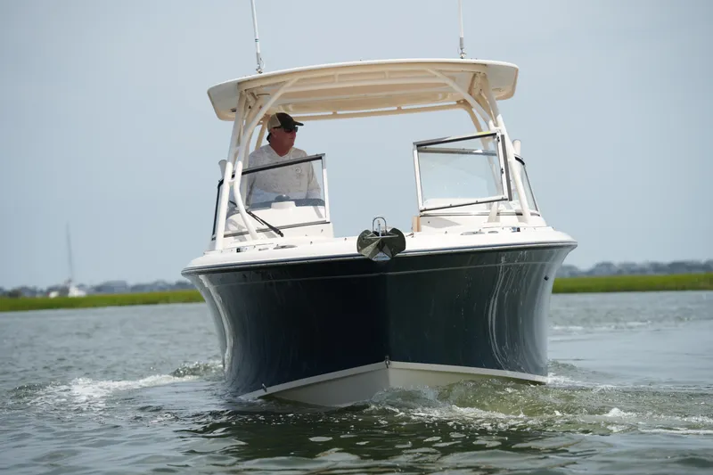 Slide: The Image of 2023 Grady-White Freedom 235 boat cruising on calm water. - 4