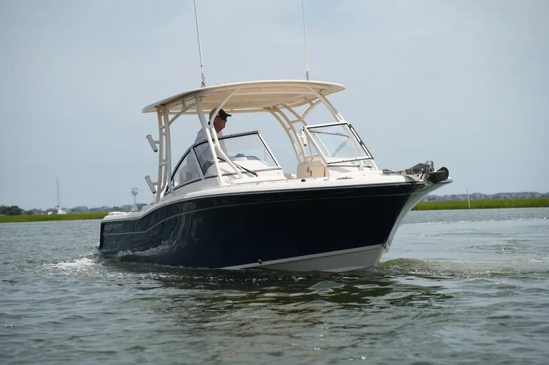 Slide: The Image of 2023 Grady-White Freedom 235 boat cruising on calm water. - 5