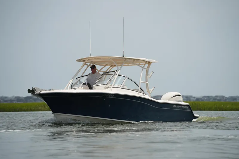 Slide: The Image of 2023 Grady-White Freedom 235 boat cruising on calm water. - 8