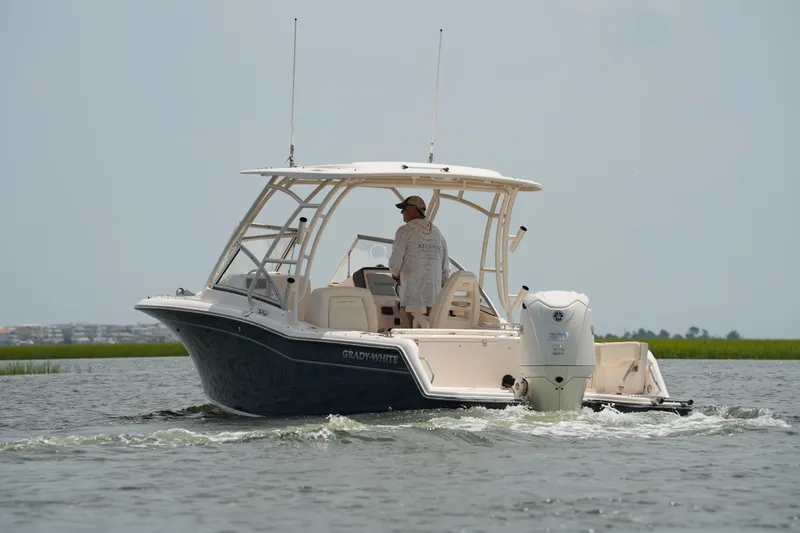 Slide: The Image of 2023 Grady-White Freedom 235 boat cruising on water, featuring sleek design and powerful engine. - 9