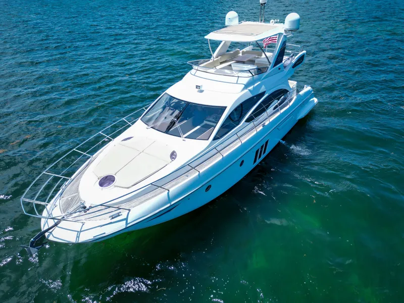 Slide: The Image of 2015 Azimut 54 Fly yacht cruising on clear blue water. - 14