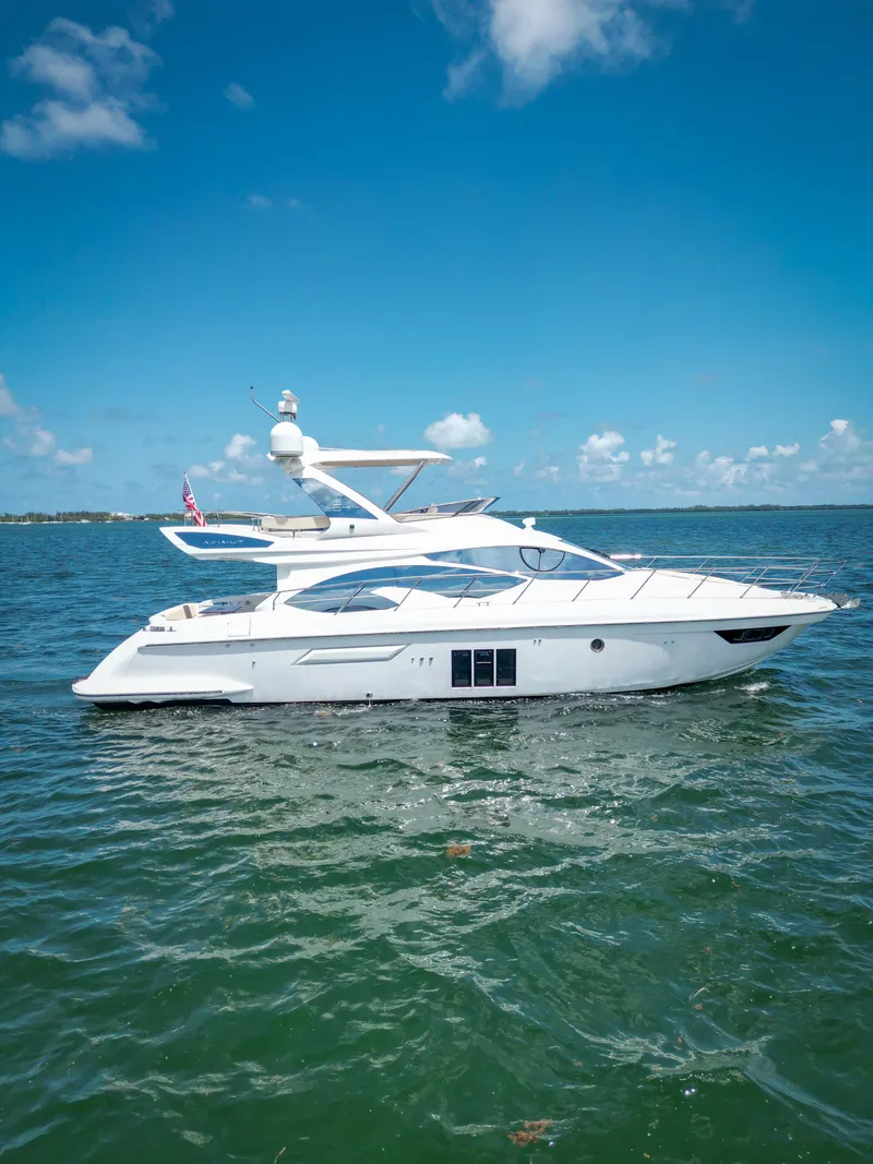 Slide: The Image of 2015 Azimut 54 Fly yacht cruising on clear blue waters under a sunny sky. - 23