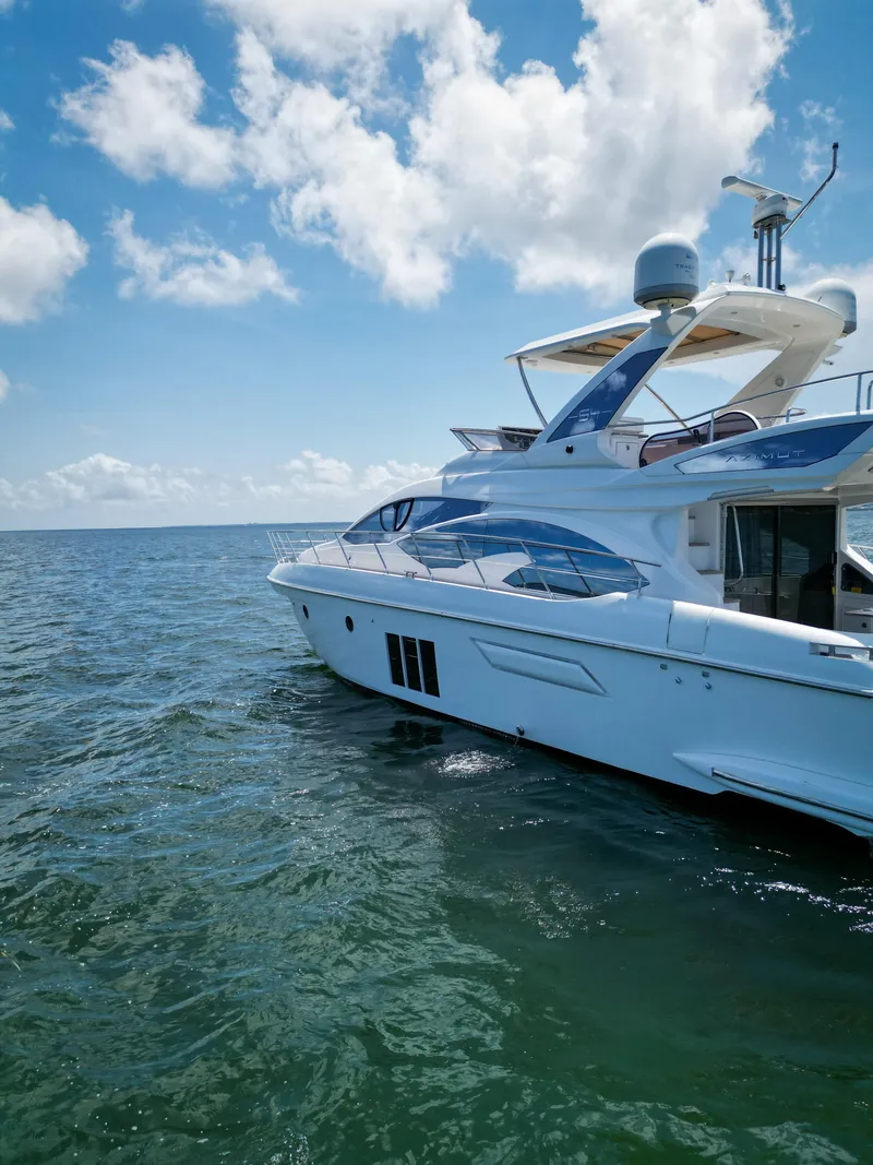 Slide: The Image of Azimut 54 Fly 2015 yacht cruising on open water under a clear blue sky. - 28