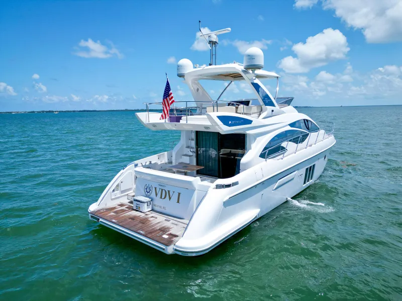 Slide: The Image of Azimut 54 Fly 2015 yacht cruising on open water under a clear blue sky. - 4