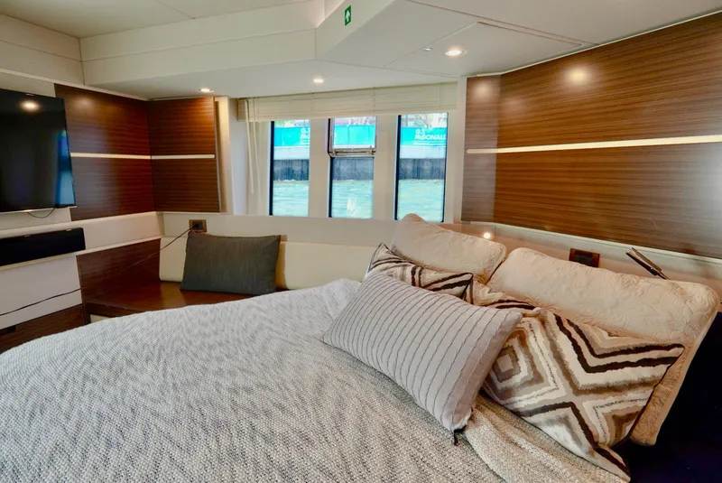 Slide: The Image of Luxurious bedroom interior of 2015 Azimut 54 Fly yacht with modern decor and large windows. - 46