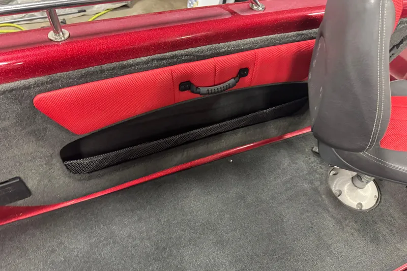 Slide: The Image of Red and gray interior of 2014 Stratos 386 XF boat, featuring storage compartment and seat. - 16