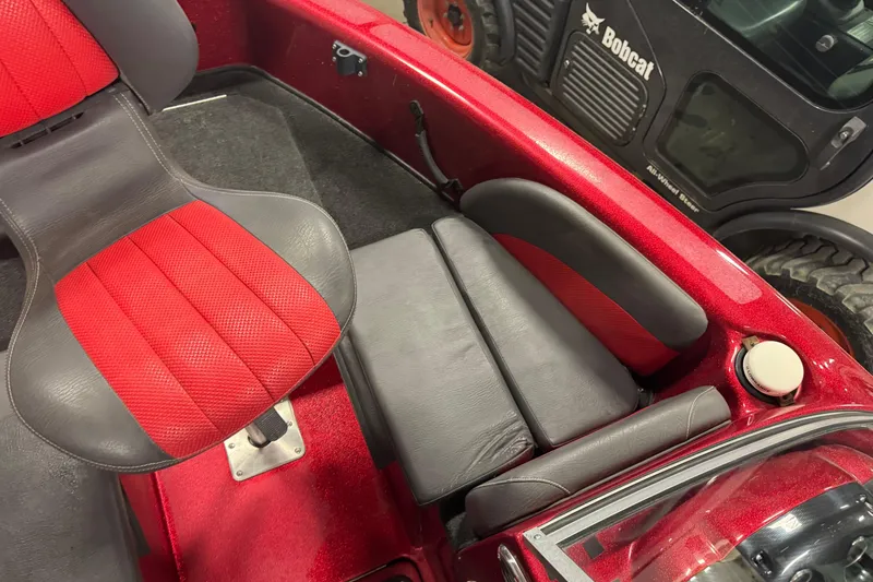 Slide: The Image of Red and black interior of a 2014 Stratos 386 XF boat, featuring cushioned seating. - 18
