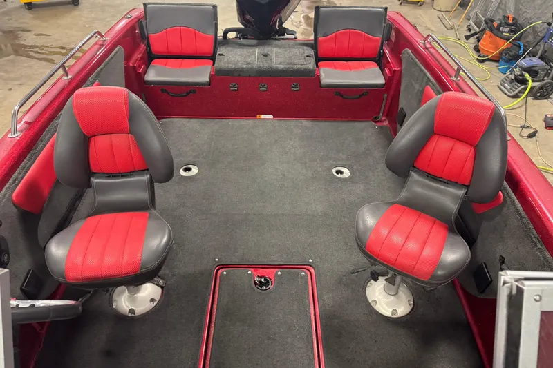 Slide: The Image of 2014 Stratos 386 XF boat interior with red and gray seating, spacious layout. - 21