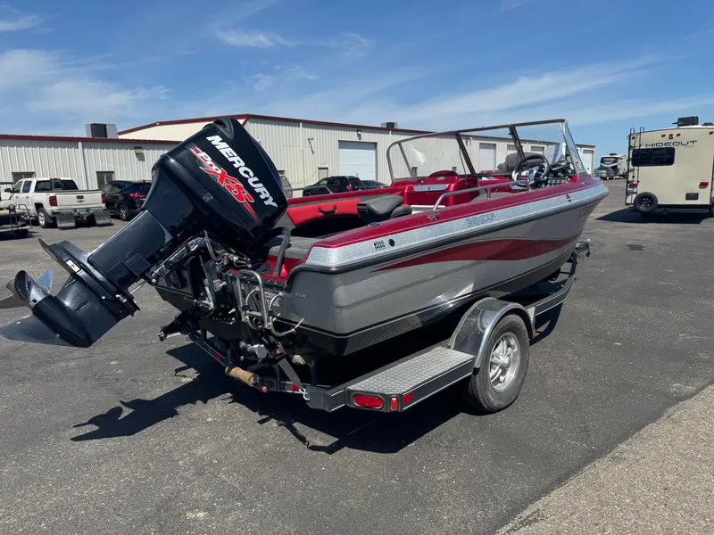 Slide: The Image of 2014 Stratos 386 XF boat with Mercury engine in a garage setting. - 3