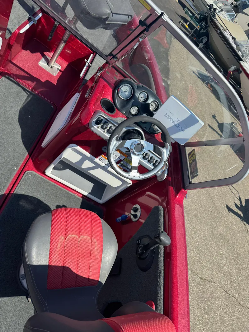 Slide: The Image of Red and black interior of a 2014 Stratos 386 XF boat with steering wheel and seat. - 7