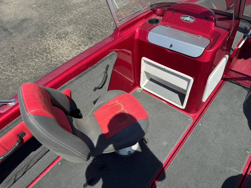 Slide: The Image of 2014 Stratos 386 XF boat cockpit with steering wheel and Lowrance display. - 8