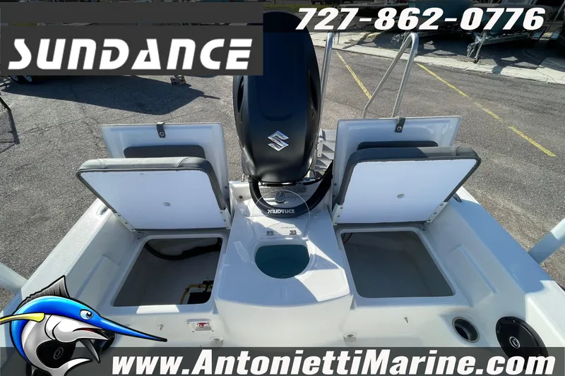 Slide: The Image of 2025 Sundance DX20 boat with Suzuki engine, open storage compartments, and marine branding. - 11