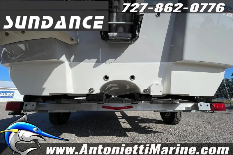 Slide: The Image of Sundance DX20 2025 boat on trailer, Antonietti Marine branding, contact number visible. - 2