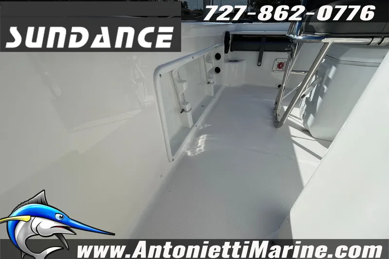 Slide: The Image of 2025 Sundance DX20 boat interior with ladder, contact info, and website details. - 21