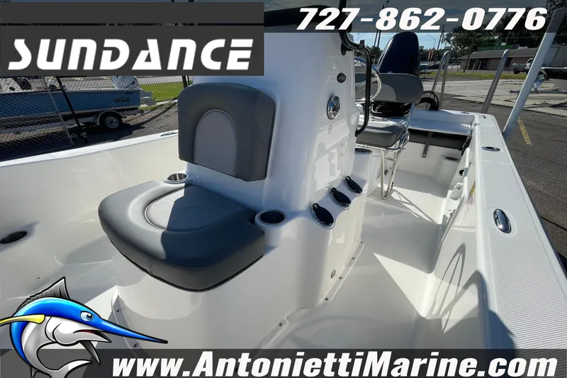 Slide: The Image of 2025 Sundance DX20 boat interior with seating, rod holders, and console, displayed at Antonietti Marine. - 34