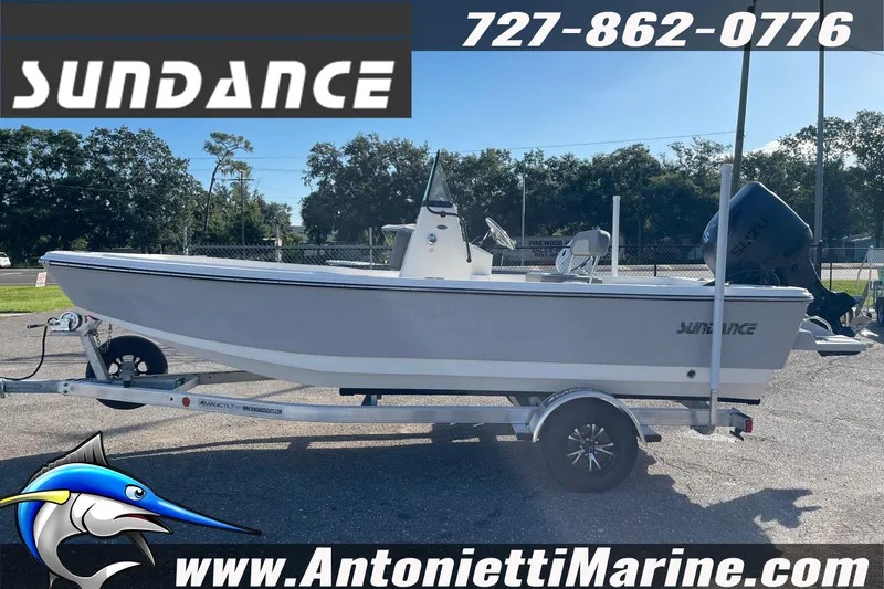 Slide: The Image of 2025 Sundance DX20 boat on trailer at Antonietti Marine dealership. - 5