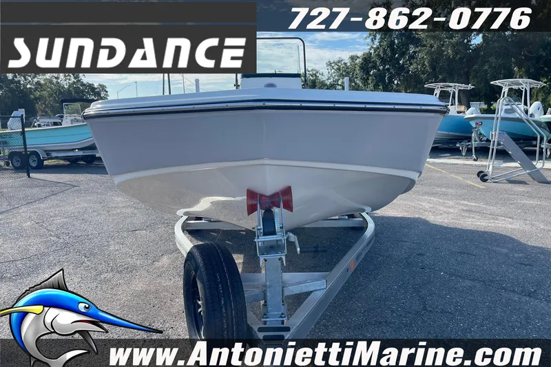 Slide: The Image of 2025 Sundance DX20 boat on trailer at Antonietti Marine dealership. - 6
