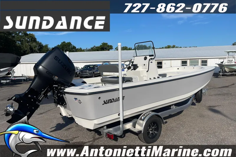 Slide: The Image of 2025 Sundance DX20 boat with Suzuki engine on trailer at Antonietti Marine dealership. - 8