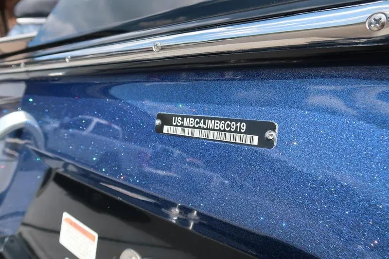 Slide: The Image of 2019 MasterCraft XT22 boat rear view with swim platform in parking lot. - 11