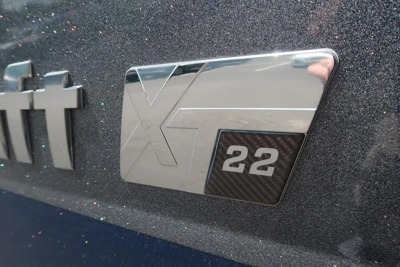 Slide: The Image of 2019 MasterCraft XT22 boat interior with sleek seating and modern design. - 13