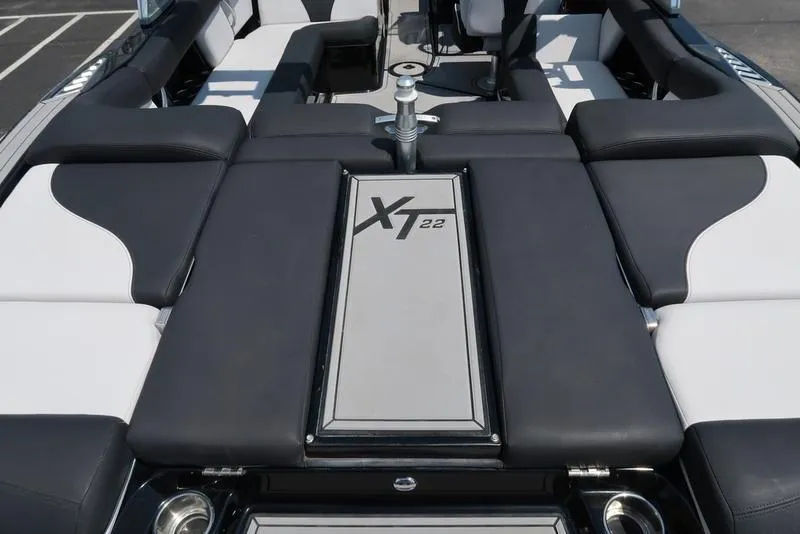 Slide: The Image of 2019 MasterCraft XT22 boat interior with sleek seating and modern dashboard design. - 14