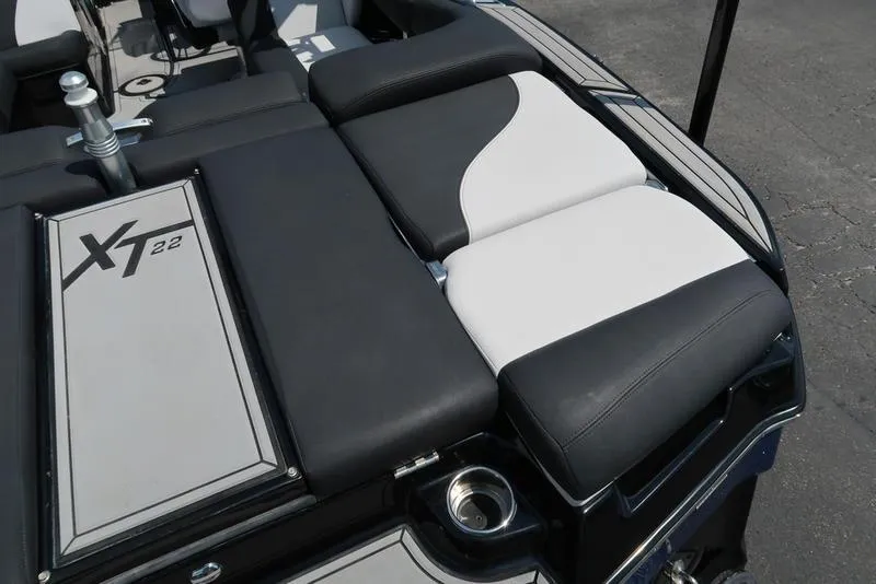Slide: The Image of 2019 MasterCraft XT22 boat interior with black and white seating. - 16