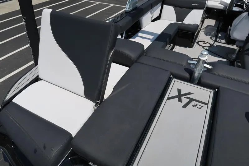 Slide: The Image of 2019 MasterCraft XT22 boat with black and white cushioned seating. - 17