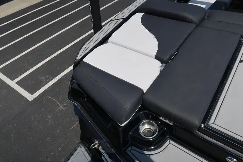 Slide: The Image of 2019 MasterCraft XT22 boat seat with black and white upholstery in a parking lot. - 18