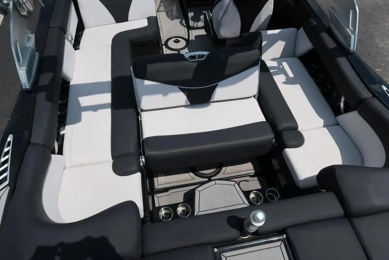 Slide: The Image of 2019 MasterCraft XT22 boat interior with black and white seating arrangement. - 2