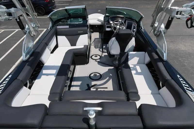 Slide: The Image of 2019 MasterCraft XT22 boat interior with sleek seating and modern dashboard. - 20