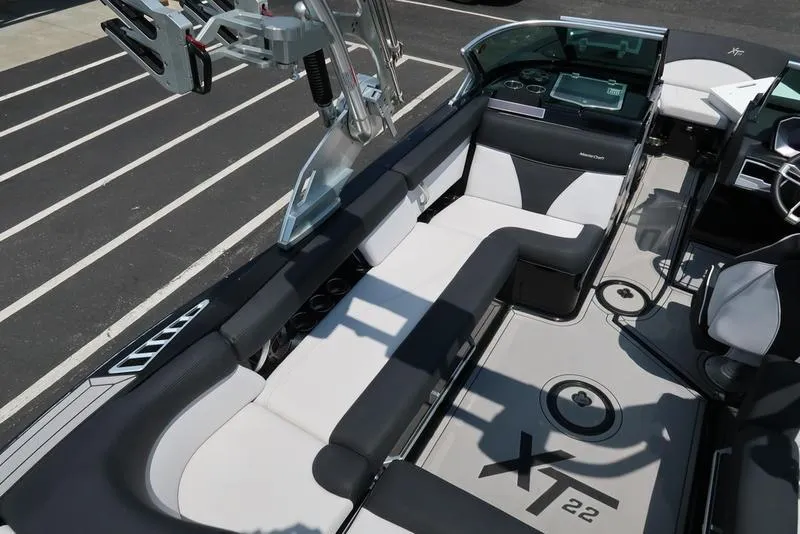 Slide: The Image of 2019 MasterCraft XT22 boat interior with sleek seating and modern dashboard. - 21
