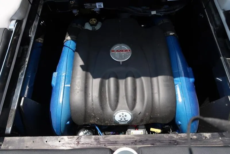 Slide: The Image of Close-up of a 2019 MasterCraft XT22 boat component in a marina setting. - 23