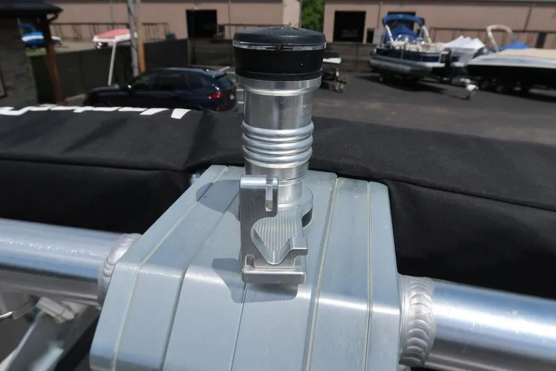 Slide: The Image of Open storage compartment of a 2019 MasterCraft XT22 boat in a parking lot. - 24