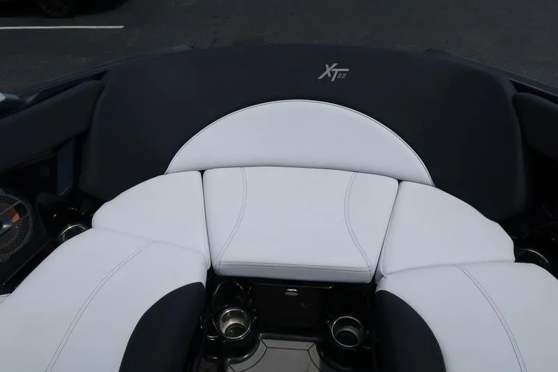 Slide: The Image of 2019 MasterCraft XT22 boat interior with sleek white and black seating design. - 32