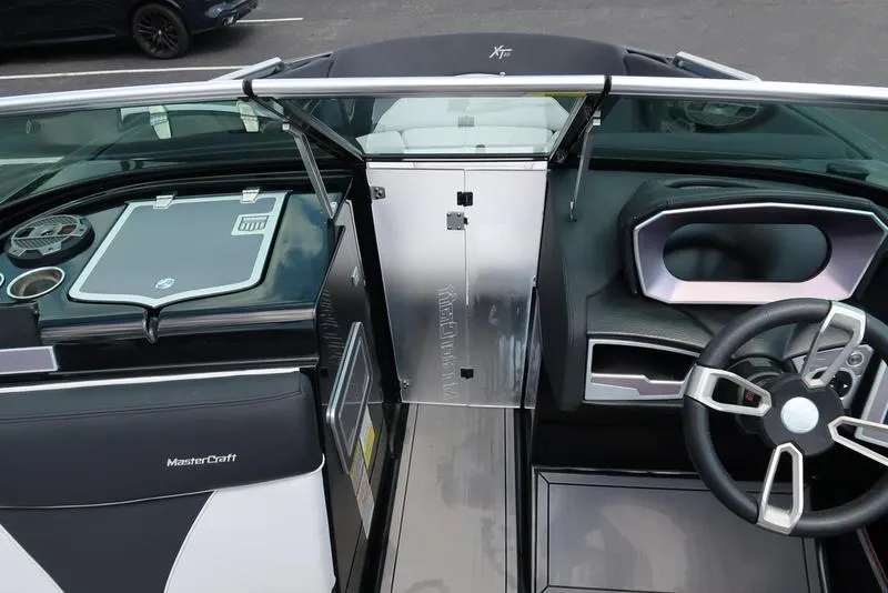 Slide: The Image of Open storage compartment in a 2019 MasterCraft XT22 boat, showcasing interior space. - 35