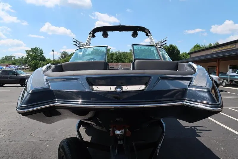Slide: The Image of 2019 MasterCraft XT22 boat on trailer under clear blue sky. - 4