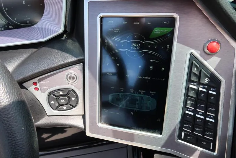 Slide: The Image of 2019 MasterCraft XT22 boat interior with black and white seating and cup holders. - 44