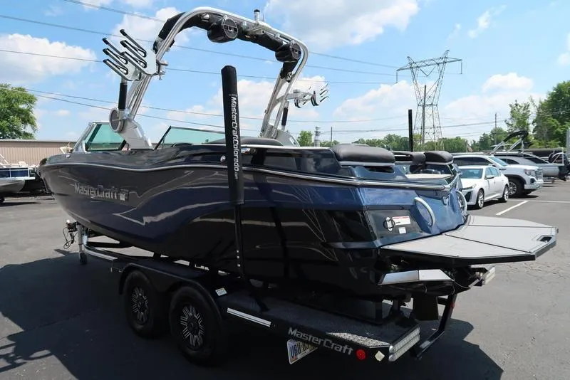 Slide: The Image of 2019 MasterCraft XT22 boat on trailer in parking lot, sunny day. - 6