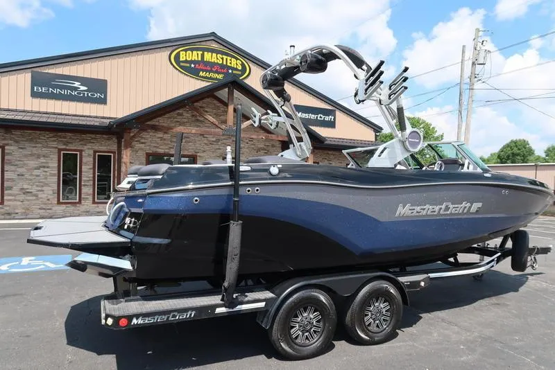Slide: The Image of 2019 MasterCraft XT22 boat on trailer outside Boat Masters Marine store. - 7