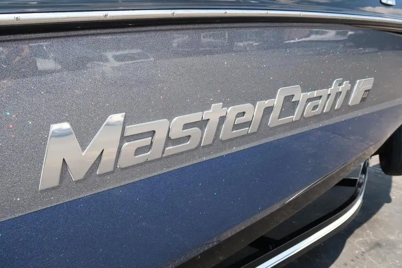 Slide: The Image of 2019 MasterCraft XT22 boat rear view with sleek design and modern features. - 9