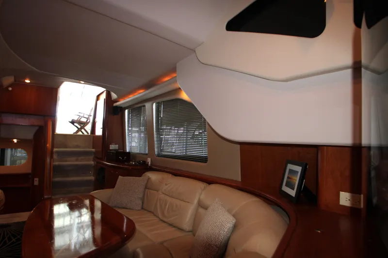 Slide: The Image of Interior of 2002 Silverton 43 Motor Yacht with plush seating and elegant wood finishes. - 11