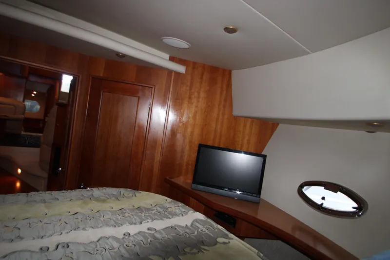 Slide: The Image of Interior of 2002 Silverton 43 Motor Yacht with TV and wooden paneling. - 15