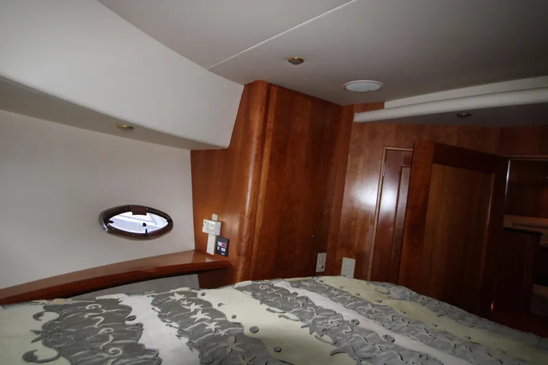 Slide: The Image of Interior cabin of 2002 Silverton 43 Motor Yacht with wood paneling and porthole window. - 17