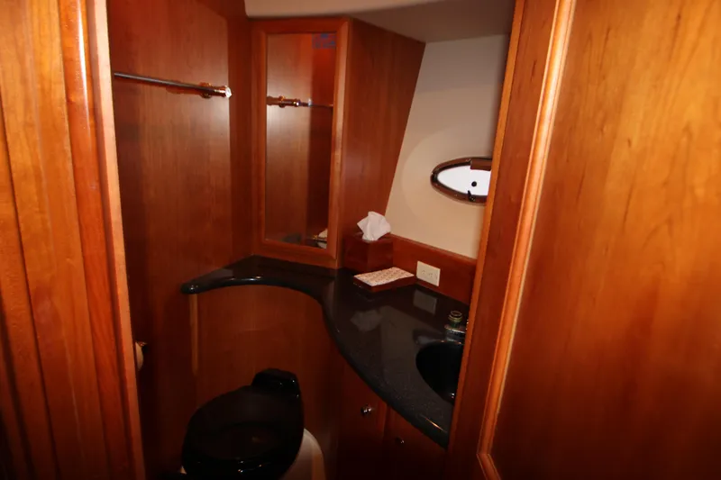 Slide: The Image of Luxurious bathroom in 2002 Silverton 43 Motor Yacht with wood paneling and modern fixtures. - 18