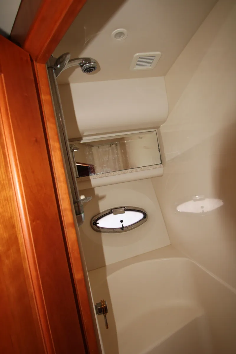 Slide: The Image of Bathroom interior of 2002 Silverton 43 Motor Yacht with shower and porthole window. - 25