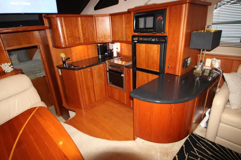 Slide: The Image of Luxurious 2002 Silverton 43 Motor Yacht kitchen with wood cabinetry and modern appliances. - 26